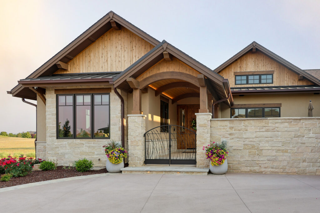 The outside of a house with a gate in front of the door at sunset.