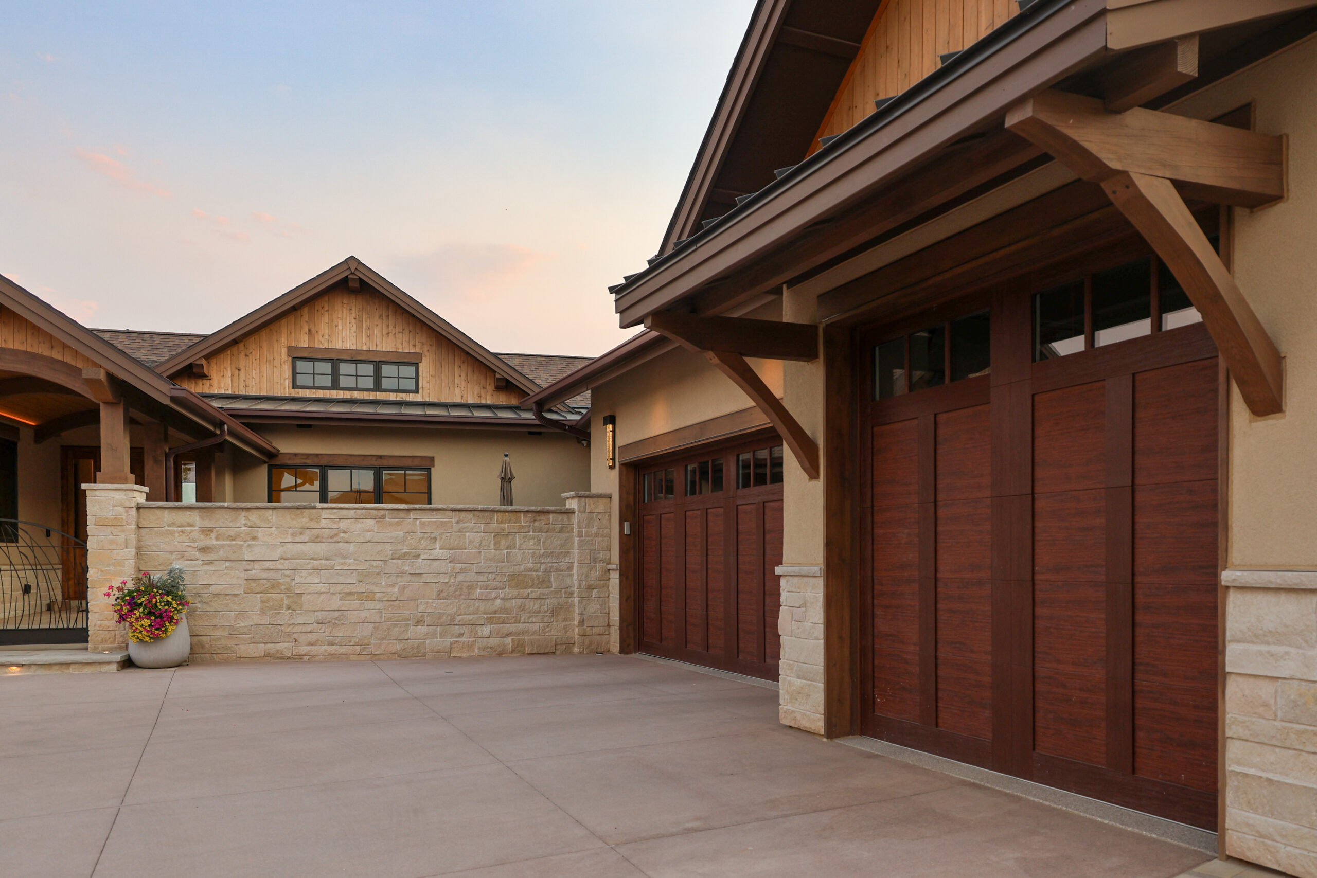 The outside of a house with large wooden garage doors.